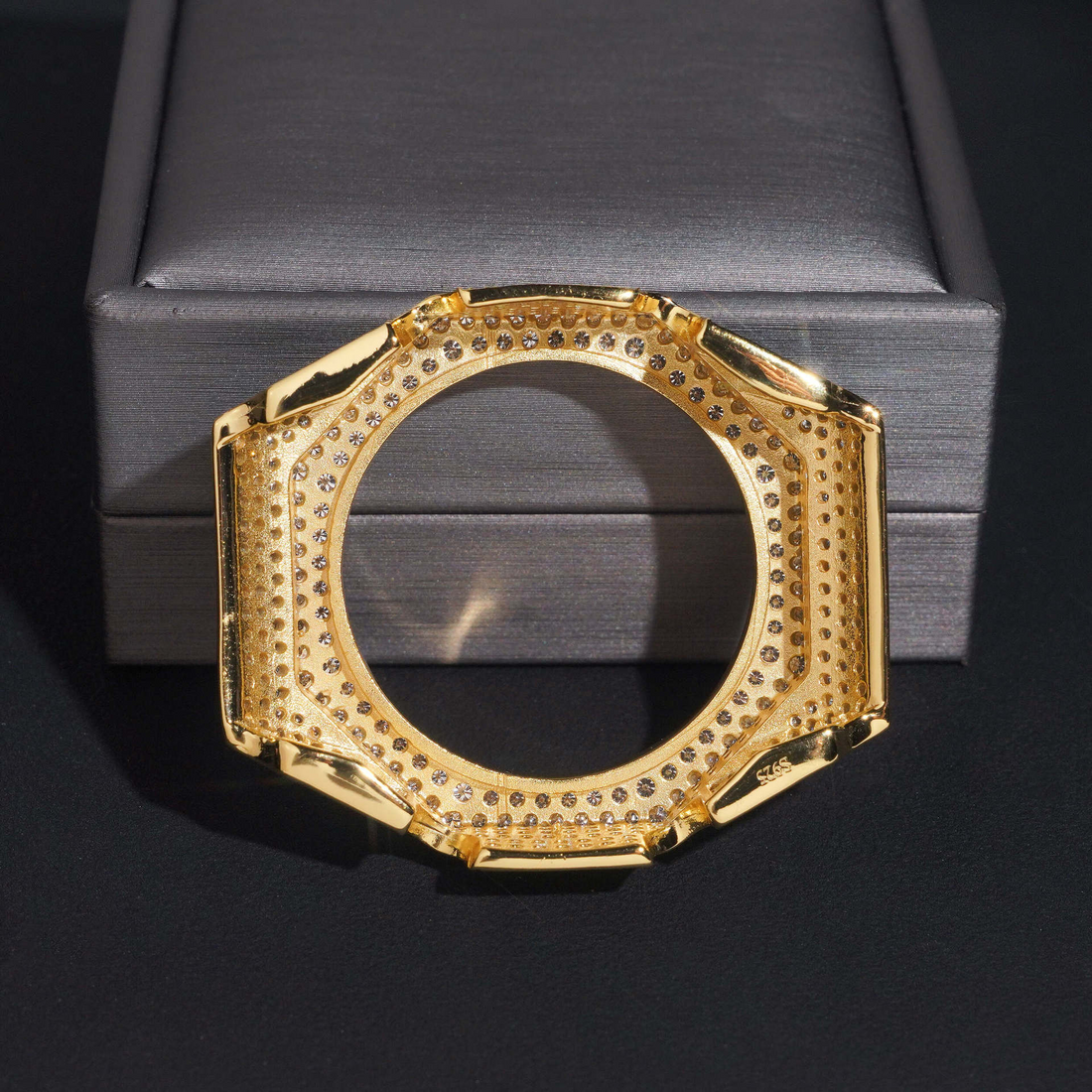 Set of gold and rose gold hexagonal watch cases on a white background